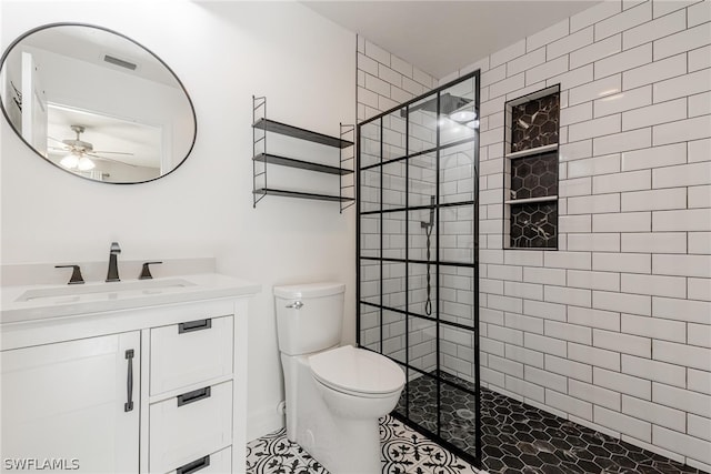 bathroom featuring an enclosed shower, toilet, vanity, ceiling fan, and tile patterned floors