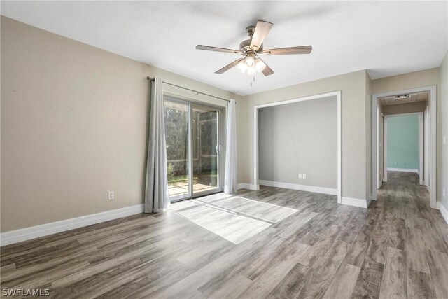 unfurnished room with hardwood / wood-style flooring and ceiling fan