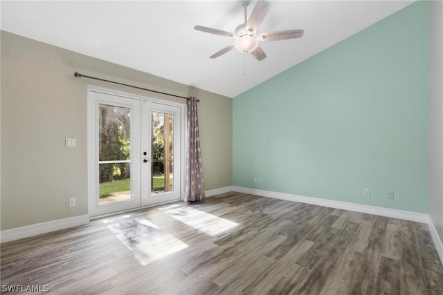 empty room featuring ceiling fan, french doors, hardwood / wood-style flooring, and lofted ceiling