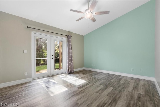 unfurnished room featuring lofted ceiling, hardwood / wood-style floors, french doors, and ceiling fan