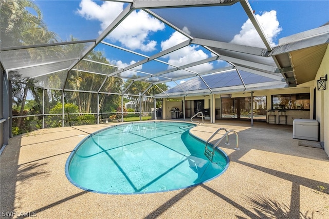 view of pool featuring a patio area and glass enclosure