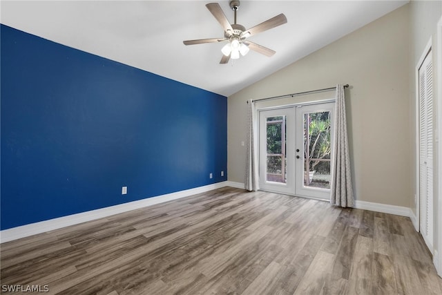 empty room with high vaulted ceiling, french doors, ceiling fan, and wood-type flooring