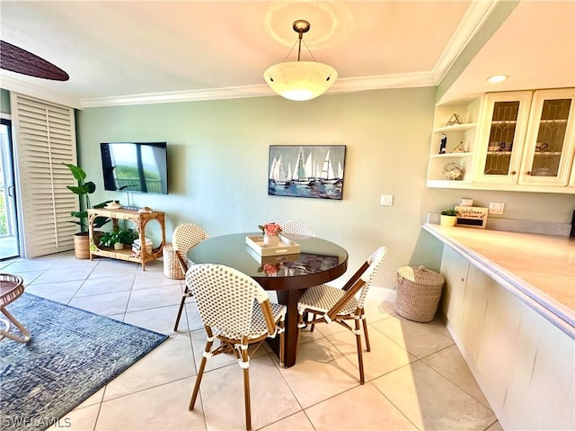 dining area with ornamental molding and light tile patterned floors