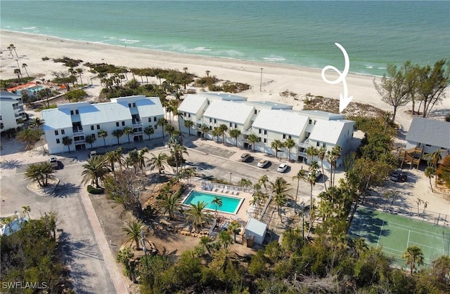 drone / aerial view featuring a water view and a beach view