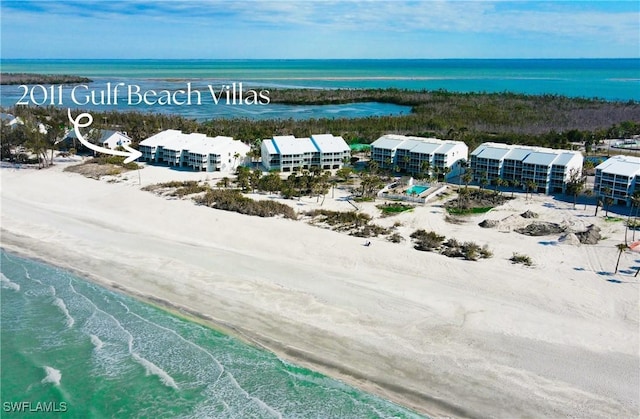 bird's eye view featuring a water view and a view of the beach