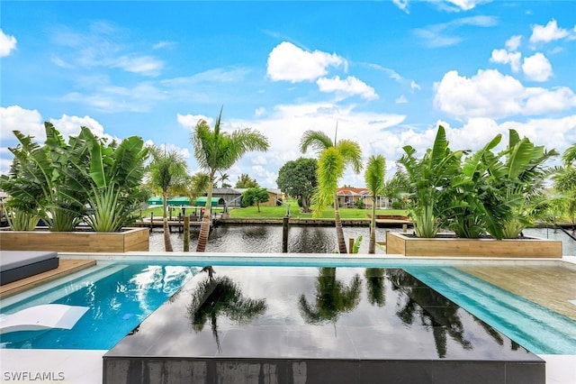 view of swimming pool featuring a water view