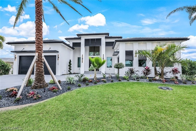 view of front of house with a garage and a front lawn