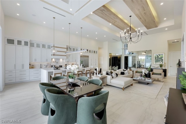 dining area with an inviting chandelier, beam ceiling, and a high ceiling