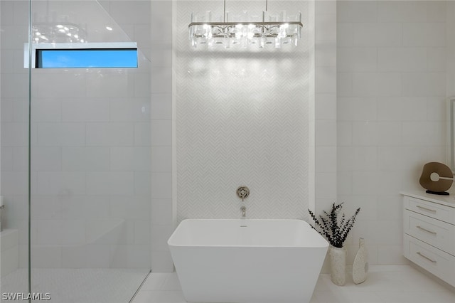 bathroom with a bathing tub, tile walls, and tile patterned floors