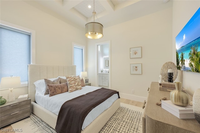 bedroom with baseboards, coffered ceiling, light wood-style flooring, beamed ceiling, and ensuite bathroom