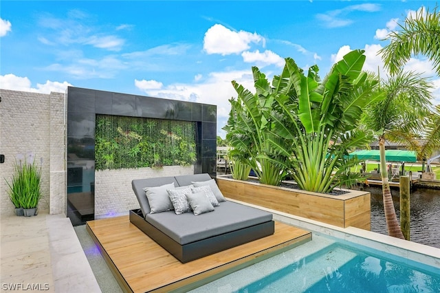 view of swimming pool featuring a patio, a water view, and outdoor lounge area