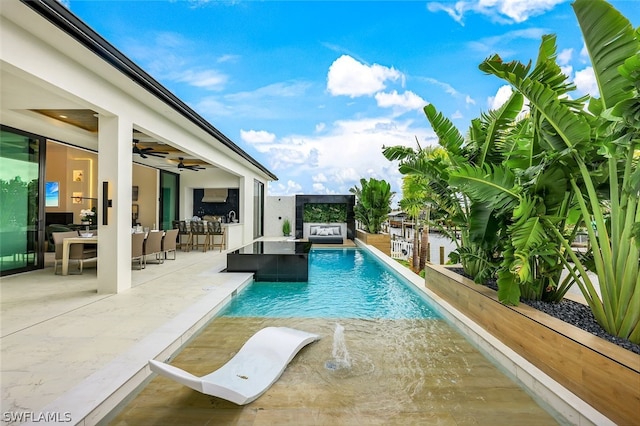 pool with a hot tub, outdoor dining space, a patio area, ceiling fan, and exterior bar