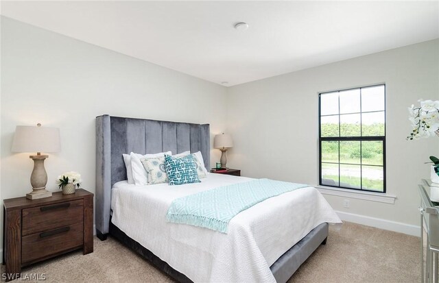 bedroom featuring light carpet