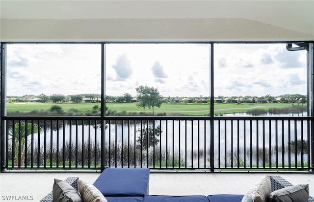 sunroom with a water view and a healthy amount of sunlight