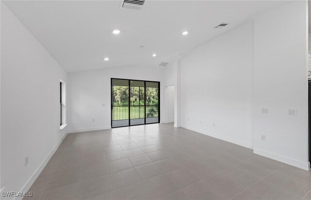 spare room with lofted ceiling, light tile patterned floors, recessed lighting, visible vents, and baseboards