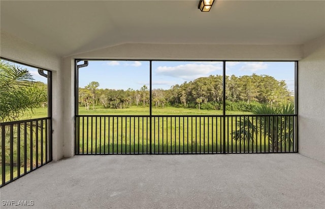 unfurnished sunroom with lofted ceiling