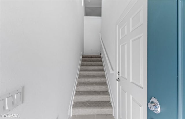 stairway with tile patterned floors