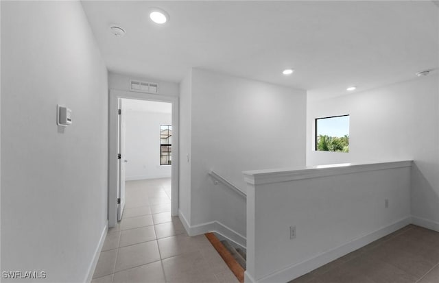 hall with baseboards, visible vents, tile patterned flooring, an upstairs landing, and recessed lighting