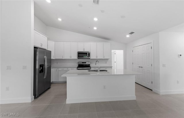 kitchen featuring visible vents, white cabinets, stainless steel appliances, light countertops, and a sink