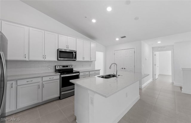 kitchen featuring light tile patterned floors, appliances with stainless steel finishes, a sink, and visible vents