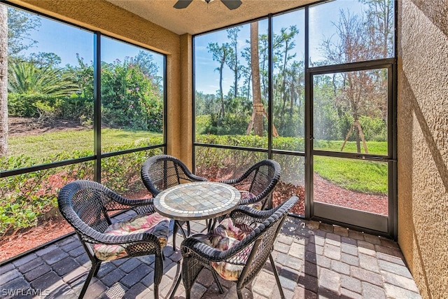 sunroom with a ceiling fan