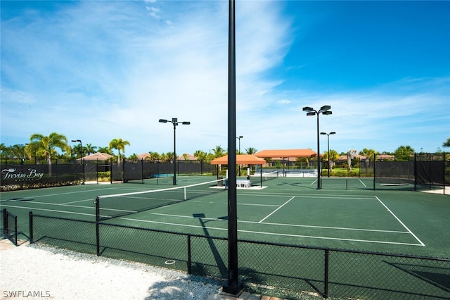 view of tennis court with fence