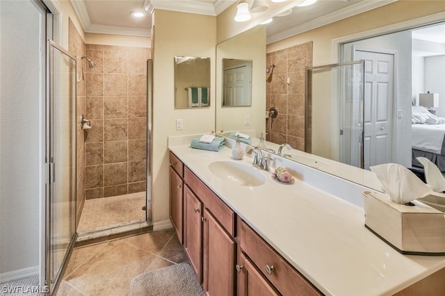 ensuite bathroom with ornamental molding, ensuite bathroom, tile patterned flooring, vanity, and a shower stall