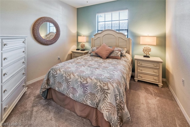 bedroom featuring baseboards and dark carpet