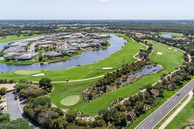 birds eye view of property with a water view and view of golf course