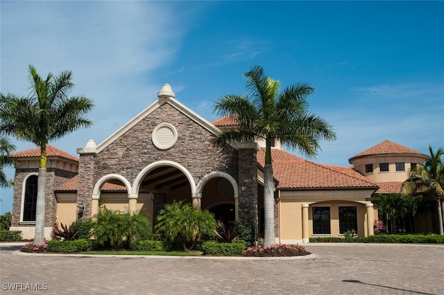 view of front of house with a tiled roof and stucco siding