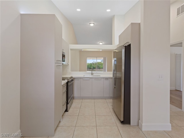 kitchen with light tile patterned floors, recessed lighting, light countertops, visible vents, and appliances with stainless steel finishes