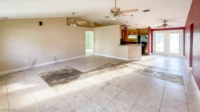 unfurnished living room featuring light tile patterned flooring, vaulted ceiling, ceiling fan, and french doors