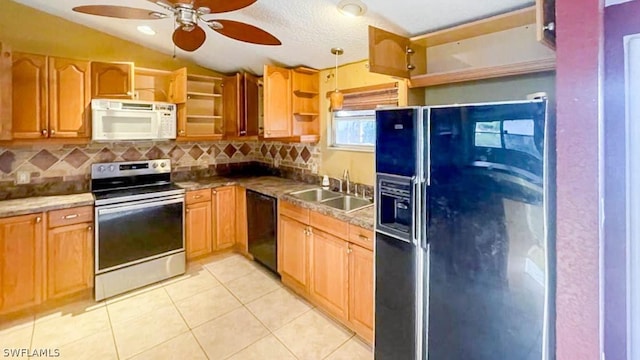 kitchen with black appliances, sink, vaulted ceiling, ceiling fan, and light tile patterned floors