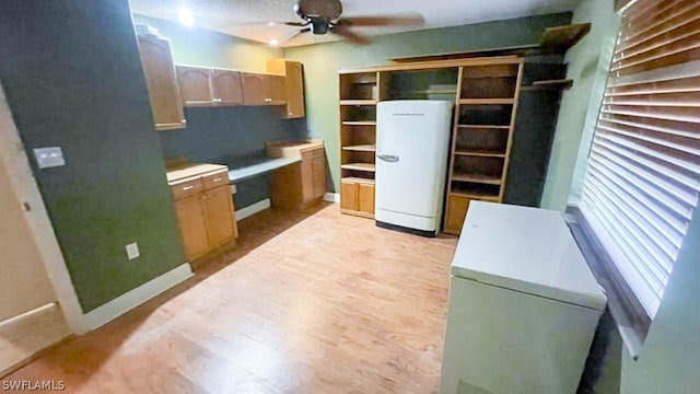 kitchen featuring ceiling fan, refrigerator, and light wood-type flooring