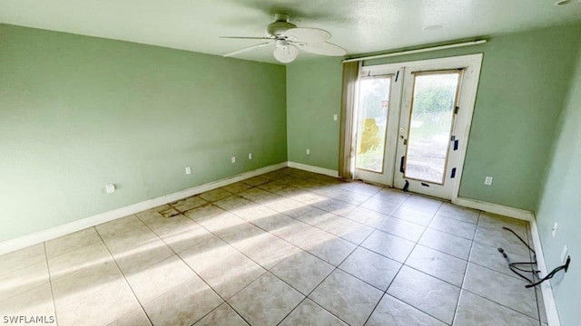 unfurnished room with ceiling fan and french doors