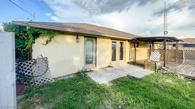 rear view of property featuring a lawn and a patio