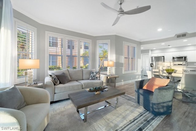 living room with ceiling fan, crown molding, and light hardwood / wood-style floors