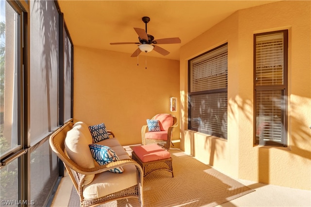 sunroom / solarium featuring ceiling fan