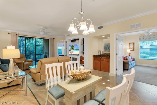 dining area with ceiling fan with notable chandelier, light tile patterned floors, and ornamental molding