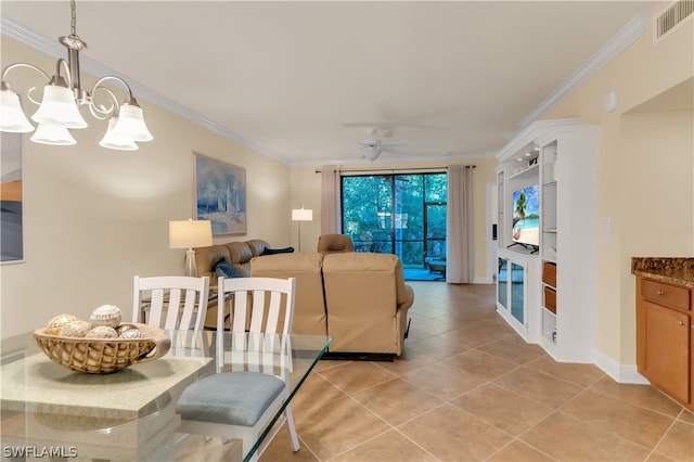 dining area with light tile patterned flooring, crown molding, and ceiling fan with notable chandelier