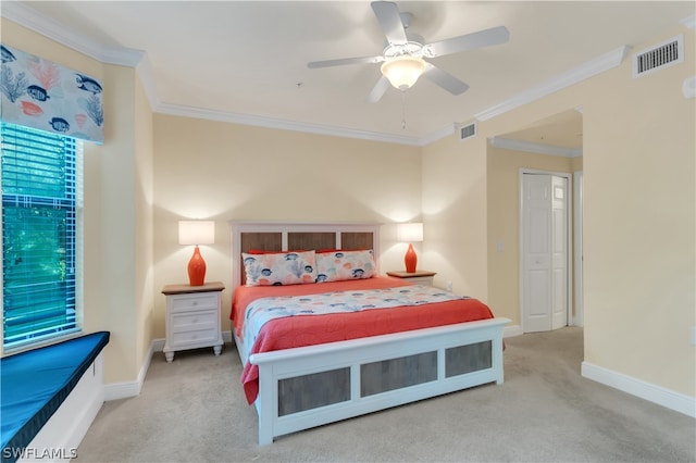 bedroom featuring light carpet, ceiling fan, ornamental molding, and a closet