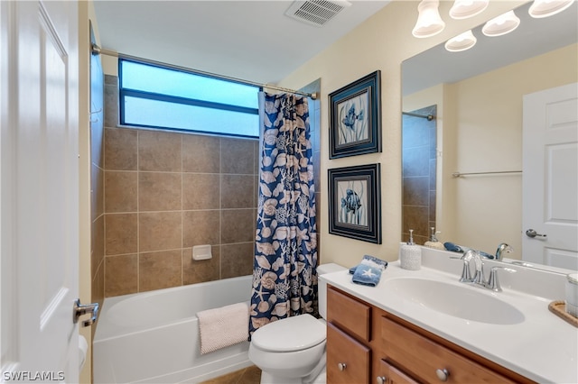 full bathroom with toilet, vanity, and shower / tub combo with curtain