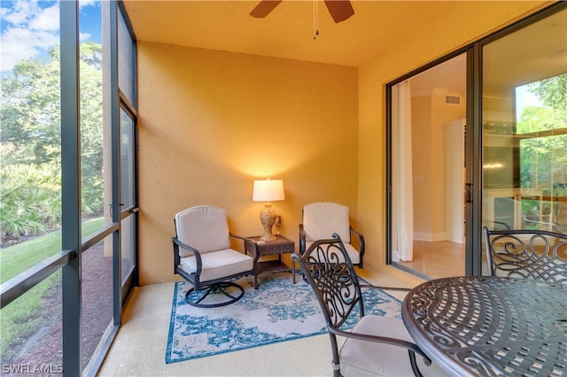 sunroom with ceiling fan