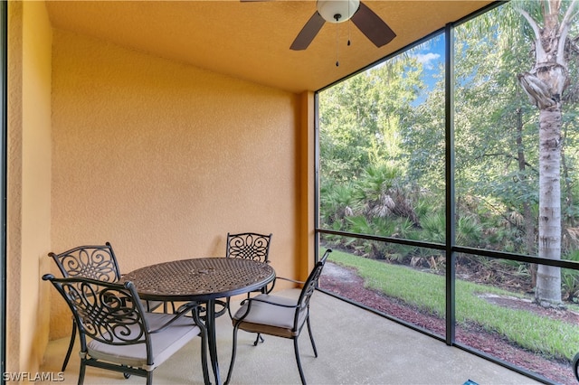 sunroom featuring ceiling fan