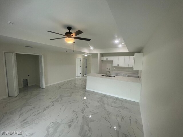 1132/1134 Harold Ave S, Lehigh Acres, FL 33973 - unfurnished living room featuring a sink, a ceiling fan, baseboards, and light marble finish flooring