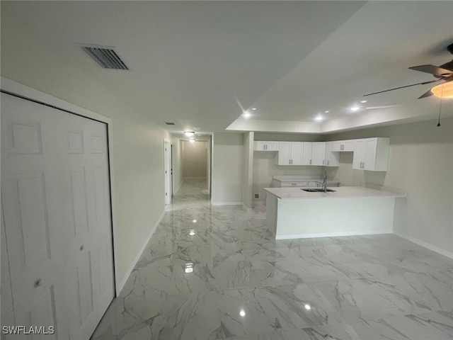 1132/1134 Harold Ave S, Lehigh Acres, FL 33973 - kitchen featuring baseboards, a sink, white cabinetry, light marble finish flooring, and a ceiling fan