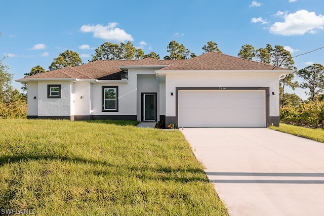 view of front of property featuring a garage and a front yard