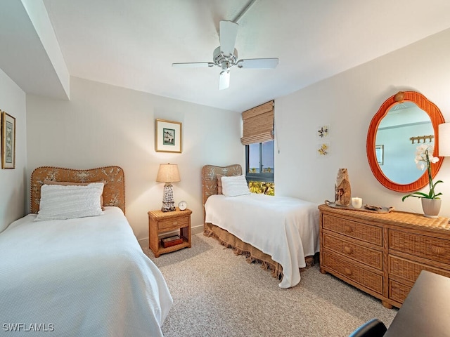 bedroom featuring light colored carpet and ceiling fan