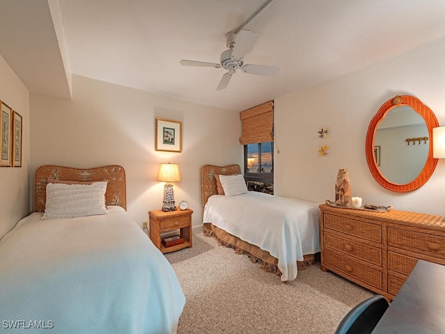 bedroom featuring ceiling fan and light colored carpet