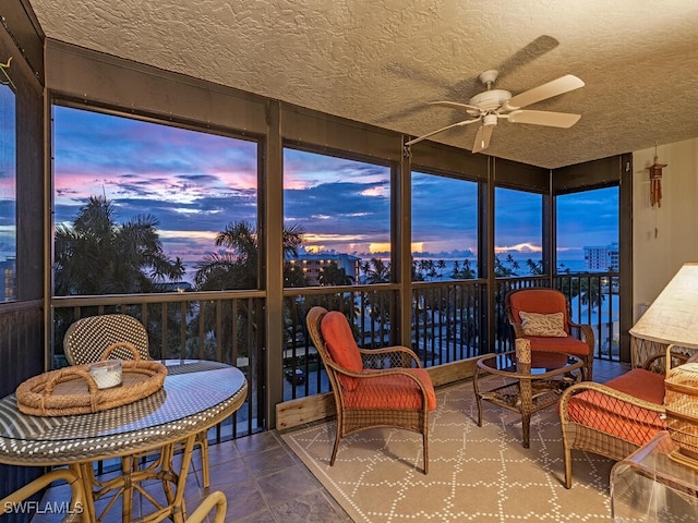 sunroom featuring ceiling fan